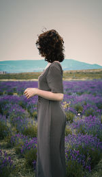 Rear view of woman standing on field