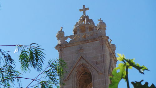 Low angle view of built structure against clear blue sky