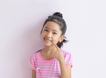 Portrait of a smiling girl over white background