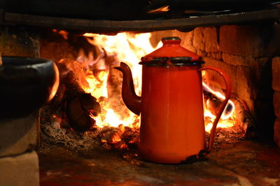 Close-up of coffee pot on wood burning stove 