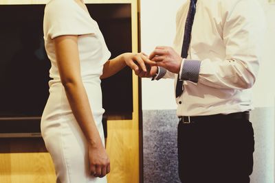 Midsection of man and woman standing at home