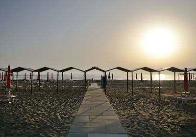 Scenic view of beach against clear sky during sunset