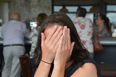 Woman covering face with hands