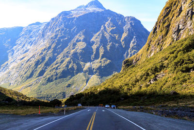 Road amidst mountains against sky