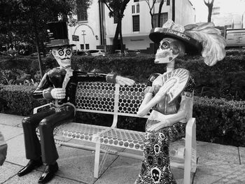 Side view of woman sitting on bench