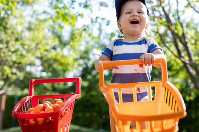 Portrait of cute baby boy standing in playground
