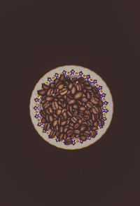 High angle view of coffee beans on table against black background