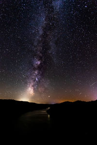 Scenic view of silhouette mountain against sky at night