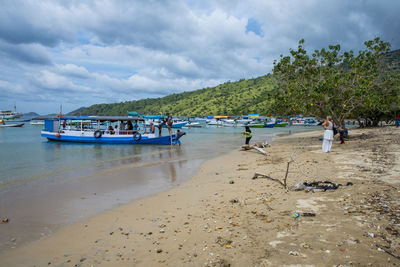 People on beach against sky