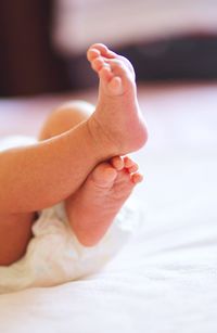 Close-up of baby feet on bed