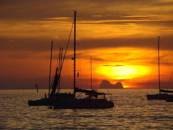 Silhouette sailboat on sea against sky during sunset