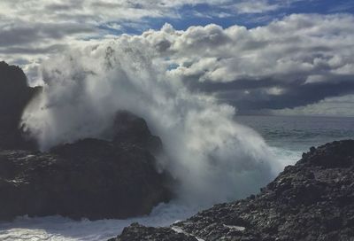 Scenic view of sea and mountains against sky