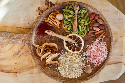 Exotic spices arranged on a round cutting board, resembling a clock