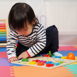 Cute girl playing with toys at home