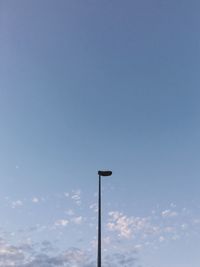 Low angle view of street light against blue sky