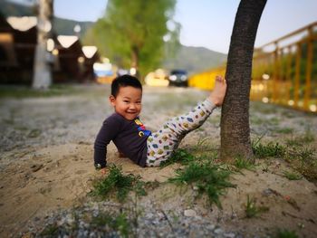 Portrait of happy boy playing in park