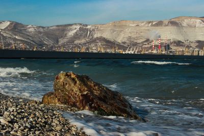 Scenic view of sea and mountains against sky