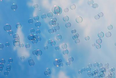 Close-up of bubbles against sky