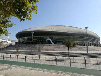 View of modern building against clear blue sky