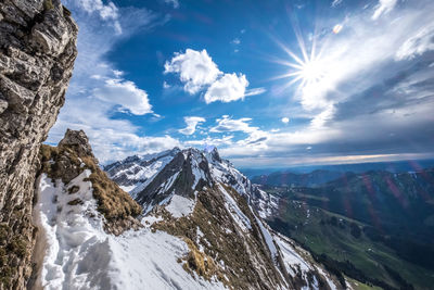 Low angle view of mountains against sky during winter