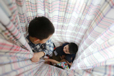 High angle view of people on bed