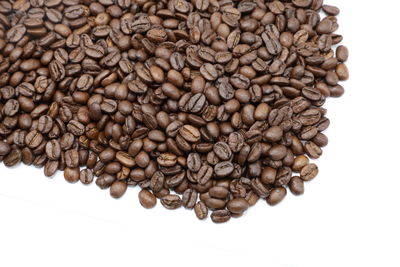 Close-up of coffee beans against white background