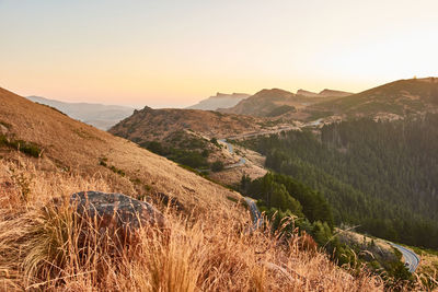 Scenic view of mountains against clear sky during sunset