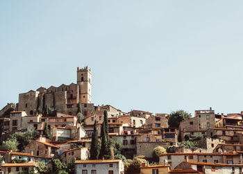 Buildings in city against clear sky