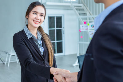 Portrait of business colleagues shaking hands