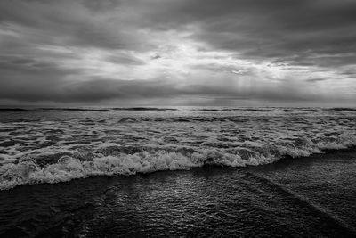 Scenic view of sea against storm clouds