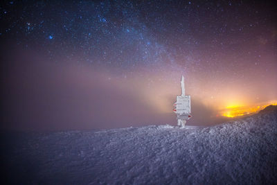 Scenic view of tower against sky at night