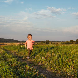 Full length of boy running on field