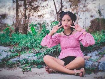 Portrait of a girl sitting on tree