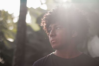 Close-up of serious young man looking away