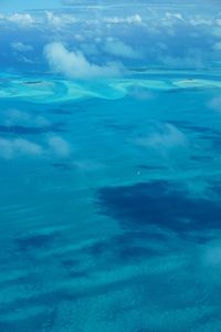Aerial view of sea against blue sky