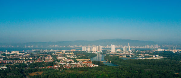 High angle view of townscape against blue sky