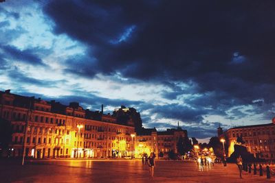 Illuminated city against sky at night