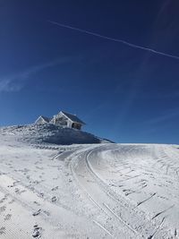 Scenic view of snowcapped mountains against blue sky