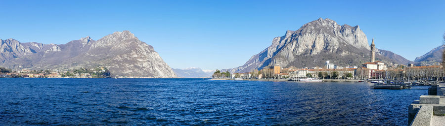 Panoramic view of sea and mountains against clear blue sky