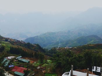 High angle view of townscape and mountains against sky
