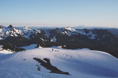 Scenic view of snowcapped mountains against clear sky on sunny day