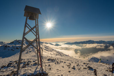 Scenic view of snow covered mountains against sky during sunset