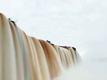 Low angle view of clothes hanging against sky