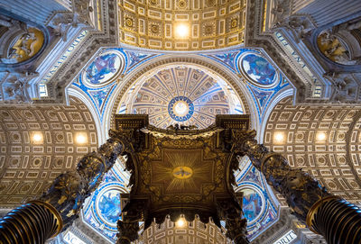 Low angle view of illuminated ceiling in temple