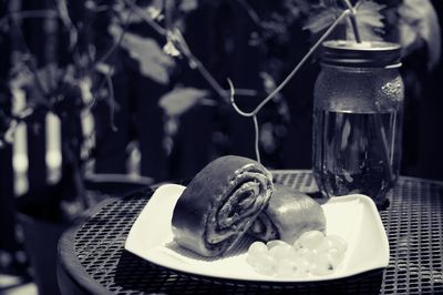 High angle view of pastry with grapes in plate on table