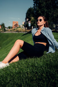 Young woman in sunglasses on field