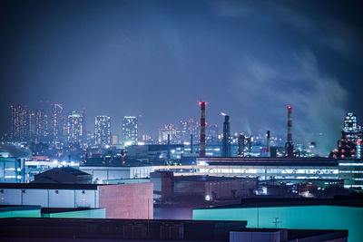 Illuminated buildings against sky at night