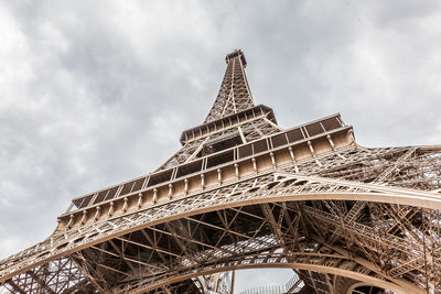 Low angle view of eiffel tower against cloudy sky