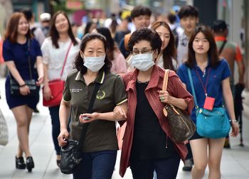 Group of people walking on street in city