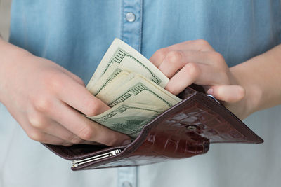 Midsection of person holding paper